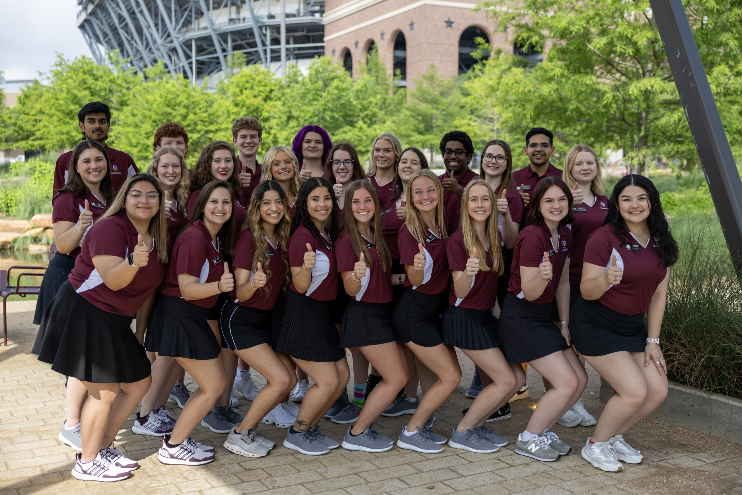 group photo of full team of Orientation Leaders in uniform on a sunny day