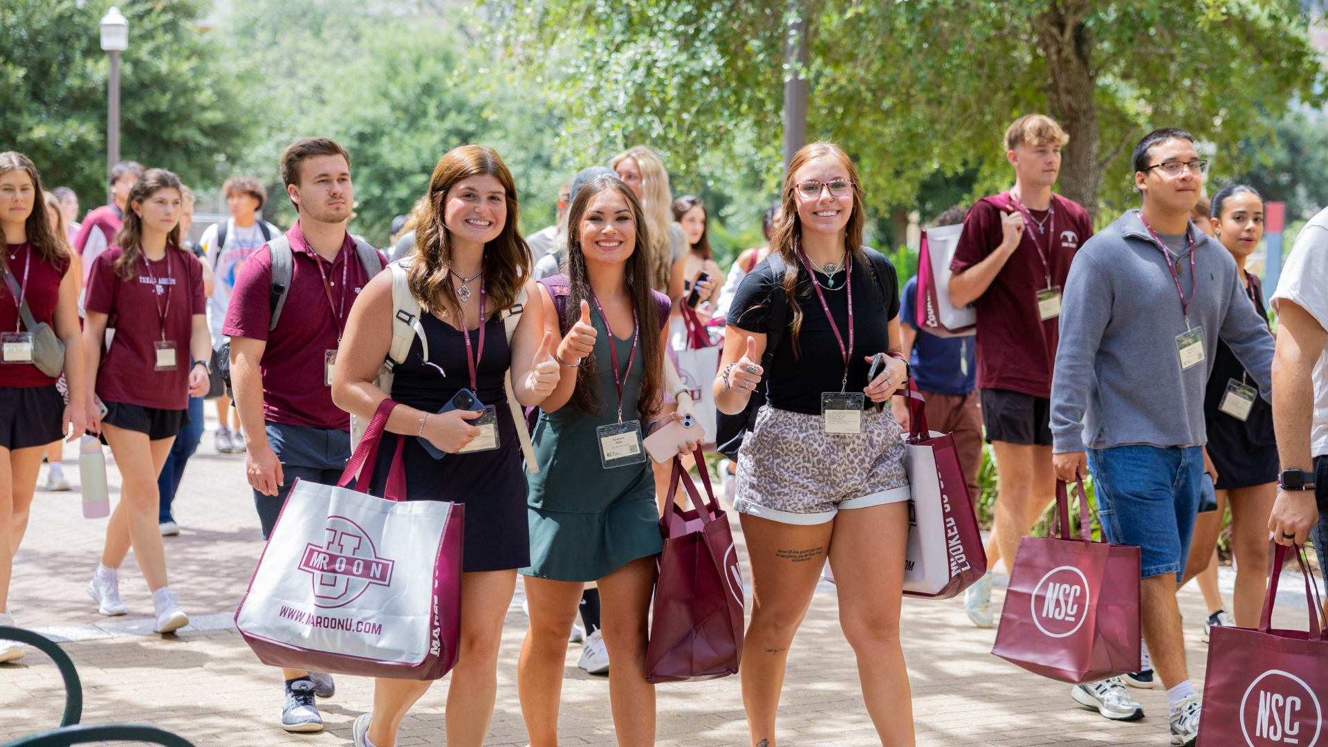 Students and their families walk down Military Walk at Texas A&M.