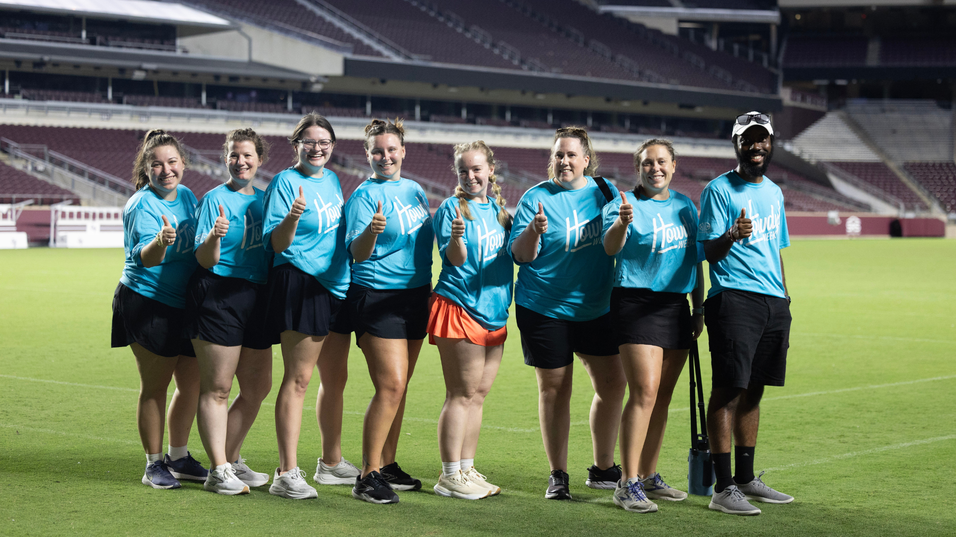 New Student and Family Programs staff gather on Kyle Field during Class Photo.